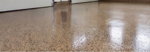A glossy speckled polyaspartic floor in a two-car garage