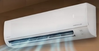 A white wall-mounted mini-split unit blowing cool air